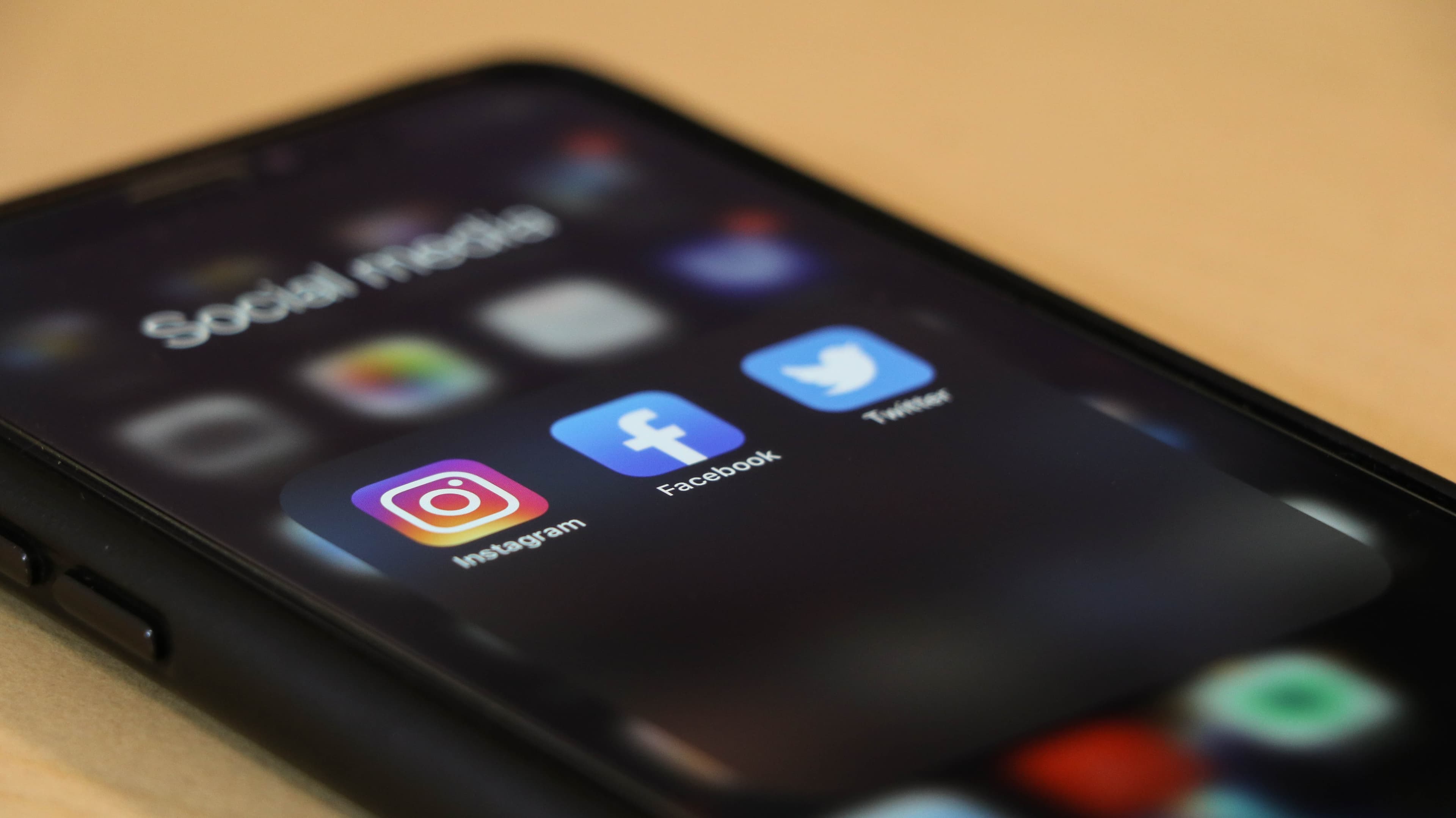 Phone with social media icons Facebook, instagram and twitter