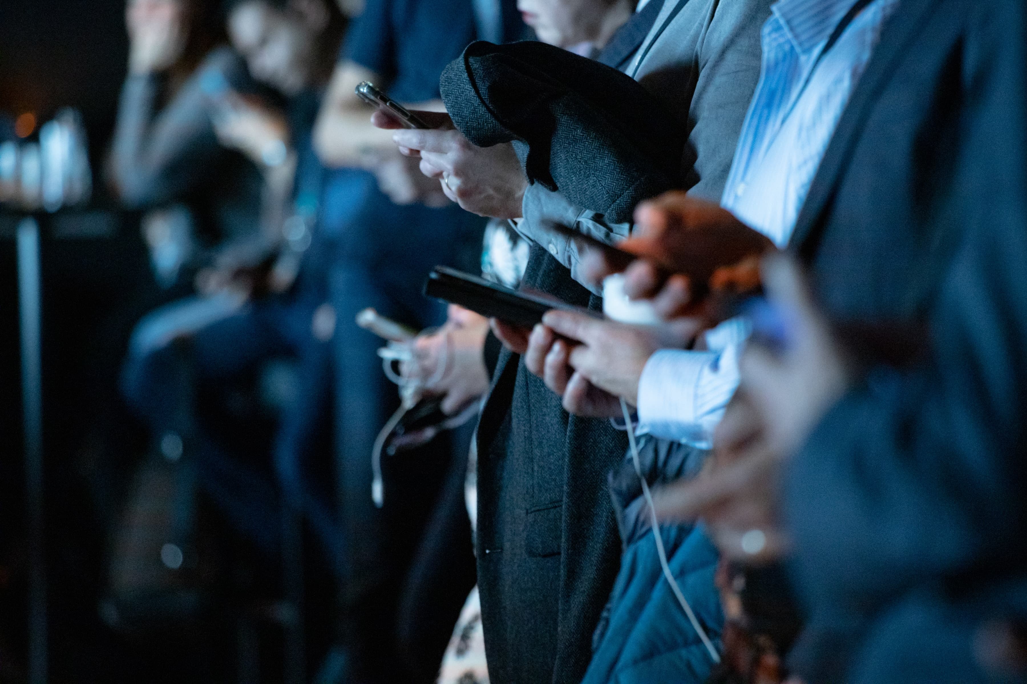 Multiple teenagers on their phones.